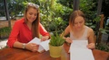 Two Women Friends In Restaurant Read Paper Menu List Chooseing Breakfast Dish