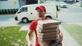Portrait Of Delivery Man With Hot Pizza Boxes Ringing On Doorbell Waiting For