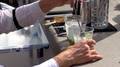 Bartender Mixing Cubical Ice Into Plastic Glasses With Fresh Green Lemonade