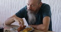Man With Long Beard Eating Hot Dog Sausage With French Fries, Real People
