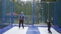 Teacher Teaches A Child To Jump On A Trampoline In A Sports Park