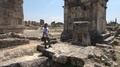 Tour Guide Standing On Ancient City Ruins Gives Information