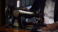 Footage Of A Tailor Sewing Two Cloths Together On His Sewing Machine