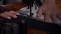 Slow Motion Shot At The Tailors Store, The Tailor Is Preparing The Final Stitch