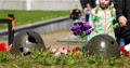Broken Helmets Of Soldiers From Military Operations Strewn With Flowers