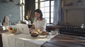 Woman Using Laptop And Having Morning Meal