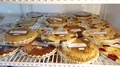 Various Dessert Pies For Sale Displayed In A Refrigerator. Slow Motion
