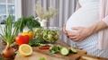 Healthy Diet During Pregnancy. Pregnant Woman Cooking Food At Home.