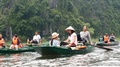 Groups Of Tourists Pass By On Small Boats Paddled By Food
