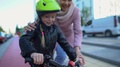 Mum Helping To Ride Bicycle Little Daughter, Supporting Kid, Sport And Hobby