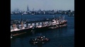 1955 - Cargo Is Unloaded From Ships In New York Harbor, With The Skyline Clearly