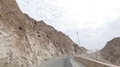 The Car Rides Along A Wild Road Between The Rocks Along Oman.
