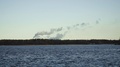 Smoke Coming From A Nuclear Power Plant In An Island - Wide Shot
