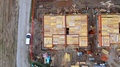 Construction Site, Materials And Workers. Aerial Birds Eye, Pan Right