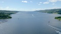 Pond5 Aerial over blue fjord surrounded by green hills with rural housing on a
