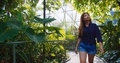 Woman Happily Walking Through Botanical Gardens, Slow Motion