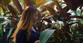 Malaysian Woman Feeling Leaves Of Heliconia Metallica, Slow Motion