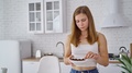 Young Woman Eating At Home. Beautiful Female Standing In The Modern Kitchen