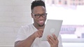 Portrait Of Serious Casual African Man Using Tablet