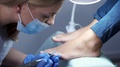 The Pedicure Master Is Removing Cuticle From Nails.