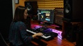 Female Sound Producer Mixing And Mastering At Sound Music Studio With Monitors
