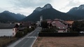 Town Hall In Commune Doussard, France Surrounded By Mountains. Aerial View Of