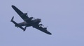 Avro Lancaster Bomber Flying Slow Motion During The Day, Blue Sky.