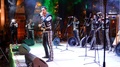 Mariachi Band On Stage At Night With Musicians, Singer, And Dancer In