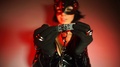 A Masked Woman In A Latex Suit Wears A Collar On A Submissive Stay Home Covid-19
