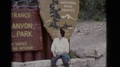 Arizona Usa-1968: White Lady Sits On Rock And Looks At Camera And The Views Of