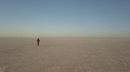 A Man Is Walking On The Perfectly Flat Ground With Nothing On Horizon, Turkey