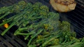 Closeup Of Broccolini And Pork Chop Cooking On Hot Grill