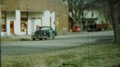 Saint Francis Kansas-1959: Blue Car In Front Of White And Brown Building And