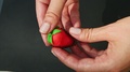 Top View Closeup Woman Hands Show Red Strawberry Shaped Marzipan Candy
