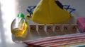 Flatlay With Wooden Blocks Spelling Corona, A Yellow Face Mask, Sanitizer And