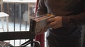Man Buying Vintage Video Cassettes With Movies On Vhs From A Thrift Shop