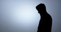 Silhouette Of A Man In A Hood Stabs With A Knife From Top To Bottom