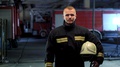 Firefighter Wearing Uniform And Putting On Yellow Protective Helmet. Video Po