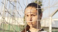 Portrait Of Young Serious Woman Football Player Wearing Uniform Looking Into