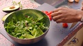 Pond5 Close up person preparing fresh vegan salad in kitchen - 8s