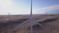 Aerial: Windmills On The Windy Plain Produce Clean Energy For Future