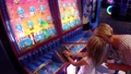 Broomfield Colorado-2019: Child Girl Playing Games Video Arcade Machine Mother