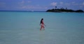 Wide Shot Of A Woman Walking With Feet In The Water In Slow Motion During Dayti