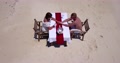 Top View Of A Man Holding A Woman's Hand On A Table In The Middle Of A Romantic