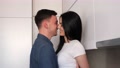 Young Couple Have Flirting In The Modern White Kitchen. Hugging In The Kitchen.