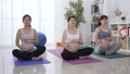 Women Seated On Exercise Mat Together