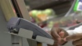 Close Up. African Hands Of Checkout Attendant Inserts Bank Card Into Pos