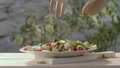 Hands Gently Toss Fresh Salad With Wooden Servers, Slow Motion