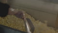 Hand Brushing Popcorn Out Of Movie Theater Popcorn Machine