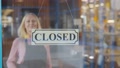 Cheerful Senior Cafe Owner Lady Closing Palce In Evening Turning Sign On Glass